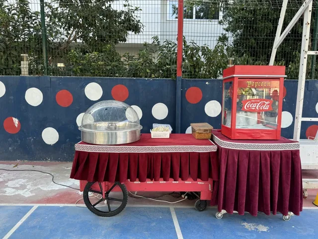 Okul bahçesinde kurulu pamuk şeker ve popcorn arabası
